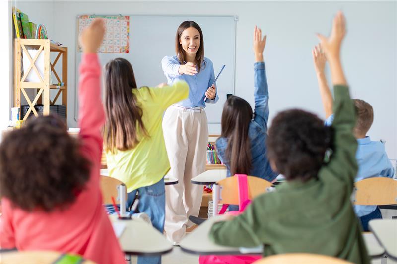 Profesora alegre interactuando con sus alumnos en clase